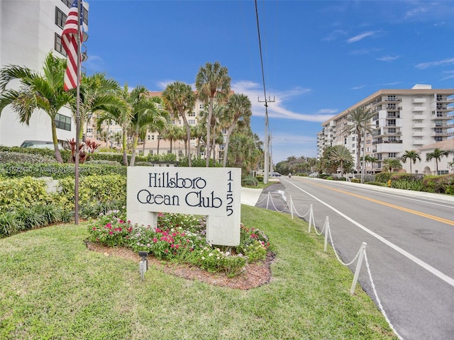 community sign featuring a lawn