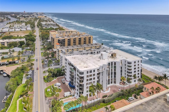 aerial view with a water view and a beach view