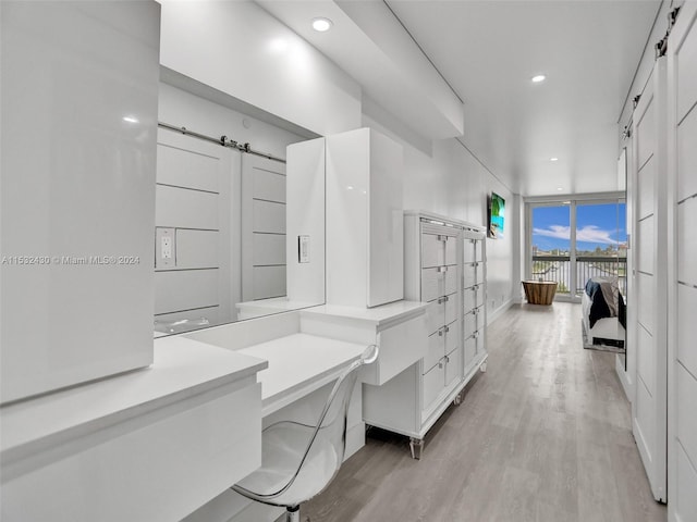 bathroom with floor to ceiling windows and wood-type flooring