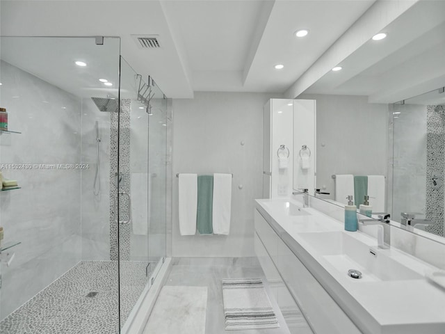 bathroom with vanity and a shower with shower door