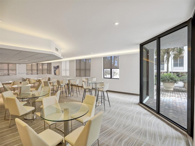 dining area with carpet floors and plenty of natural light