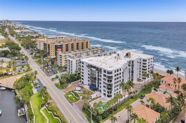 drone / aerial view featuring a water view and a view of the beach