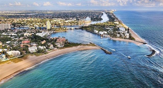 birds eye view of property with a water view and a view of the beach