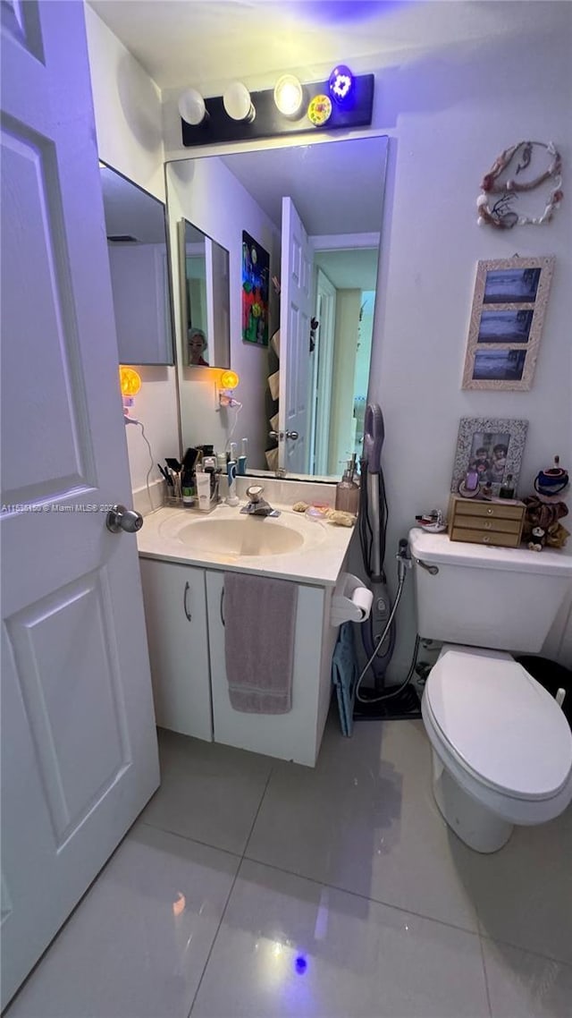 bathroom with vanity, tile patterned floors, and toilet