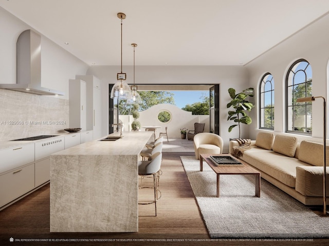 kitchen featuring plenty of natural light, wall chimney exhaust hood, white cabinets, and dark wood-type flooring