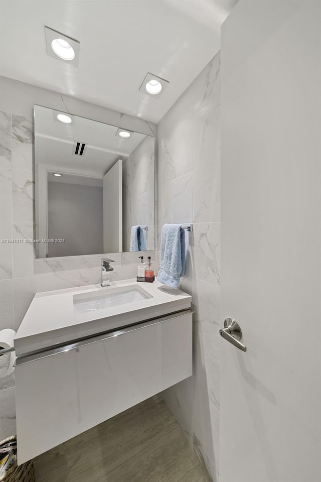 bathroom with tile walls and vanity