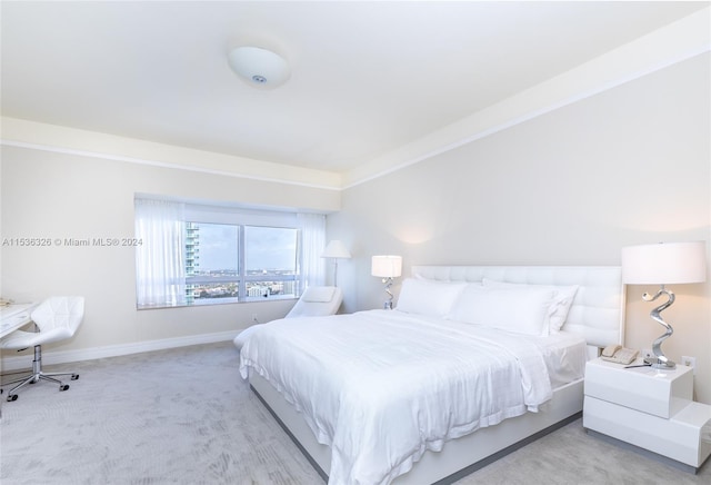 bedroom featuring light colored carpet and crown molding