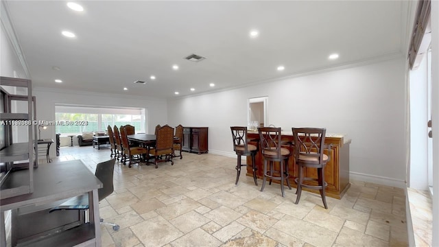 dining space with ornamental molding and light tile floors