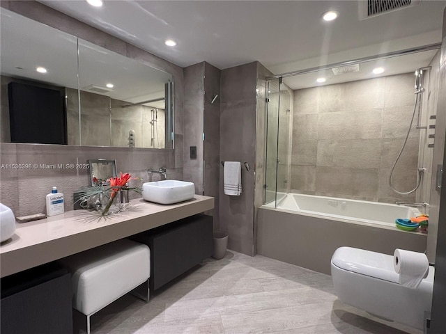 full bathroom featuring vanity, toilet, and tiled shower / bath