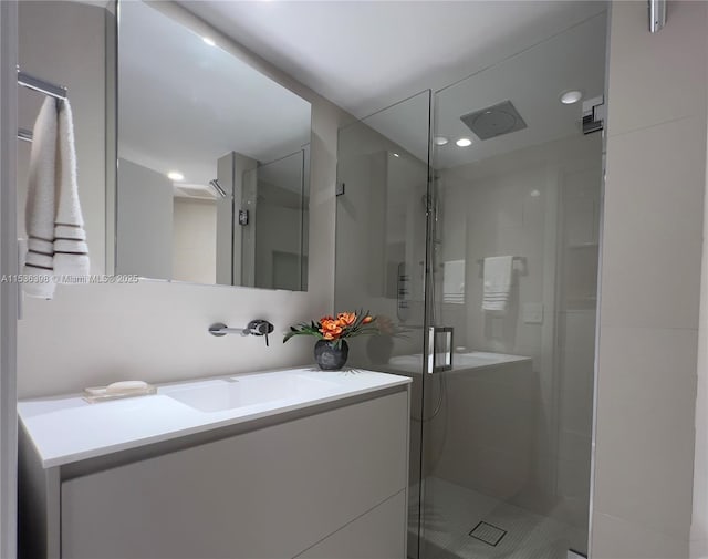 bathroom featuring vanity and an enclosed shower