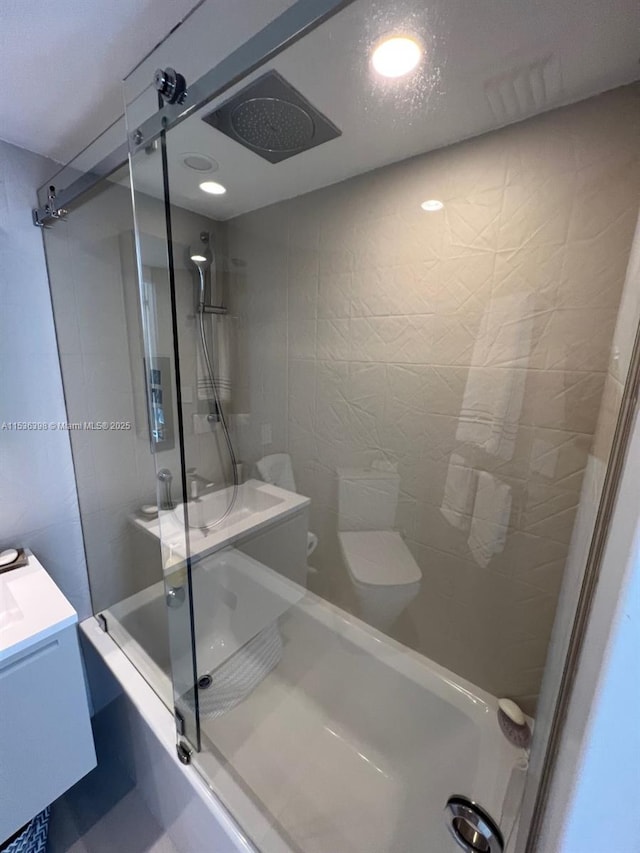 bathroom with shower / bath combination with glass door and vanity