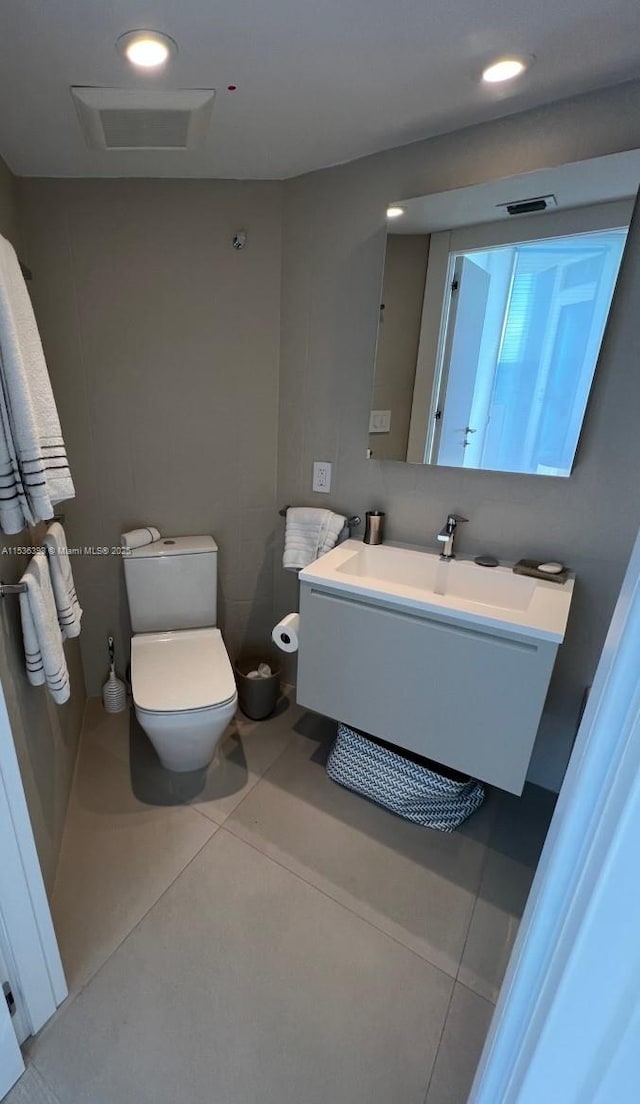 bathroom featuring toilet, vanity, and tile patterned floors