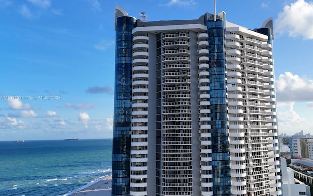 view of property featuring a beach view and a water view