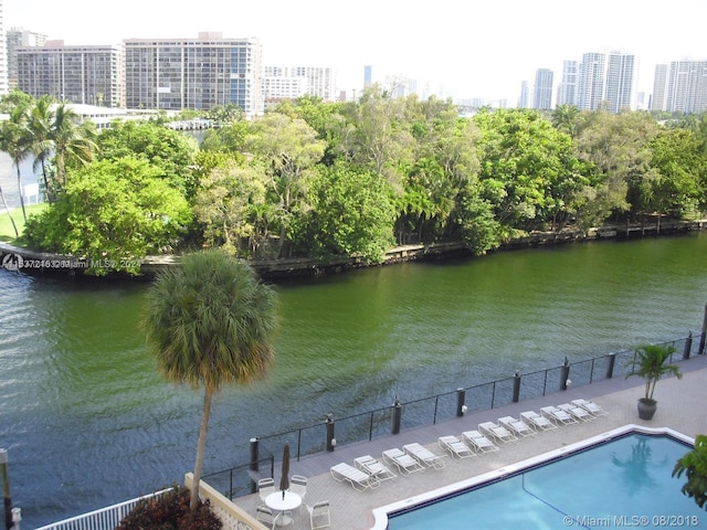 view of swimming pool with a water view