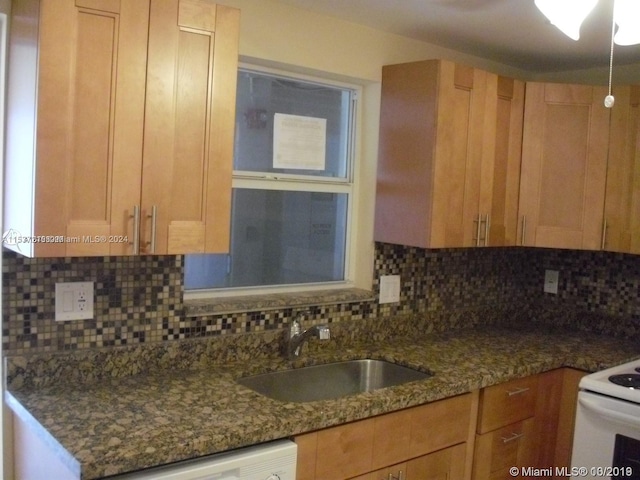 kitchen with tasteful backsplash, white electric range oven, dark stone countertops, and sink