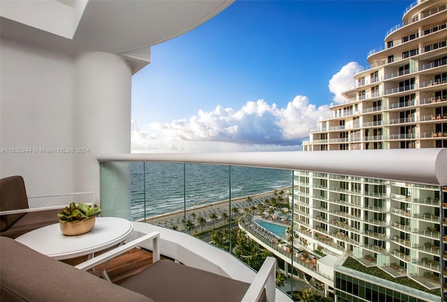 balcony featuring a beach view and a water view