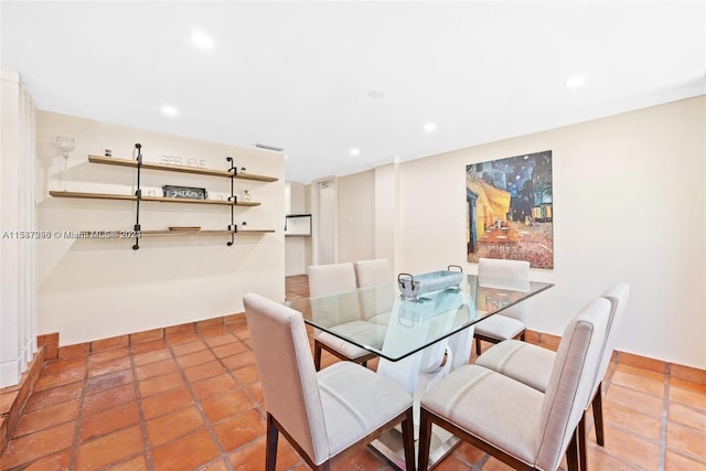 dining area featuring light tile floors