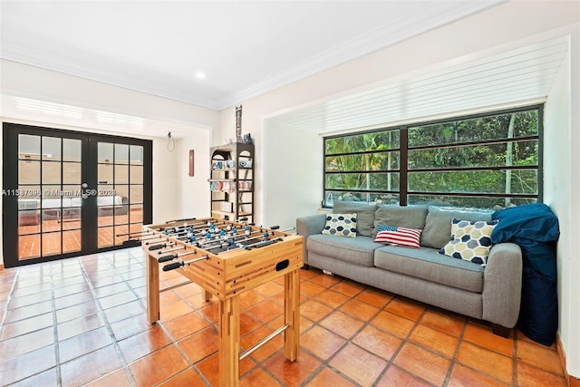 living room featuring light tile floors, french doors, and ornamental molding