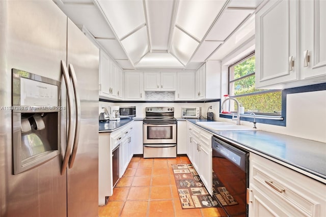 kitchen with sink, stainless steel appliances, light tile floors, white cabinets, and tasteful backsplash