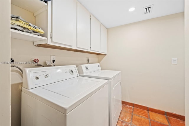 laundry room with washer and dryer, washer hookup, light tile floors, and cabinets