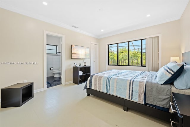 bedroom featuring crown molding and ensuite bathroom