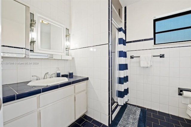 bathroom with tile floors, toilet, and tile walls