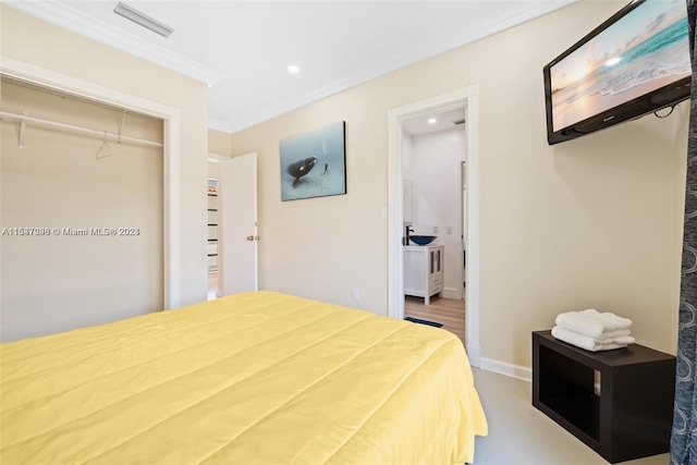 bedroom featuring ornamental molding, a closet, and light wood-type flooring