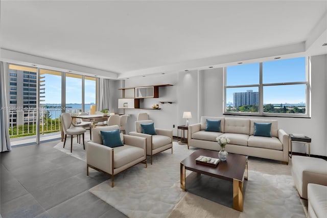 living room with a water view and light tile floors