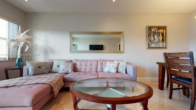 tiled living room featuring a textured ceiling