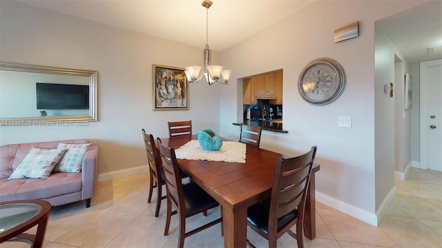 tiled dining room featuring a chandelier and vaulted ceiling