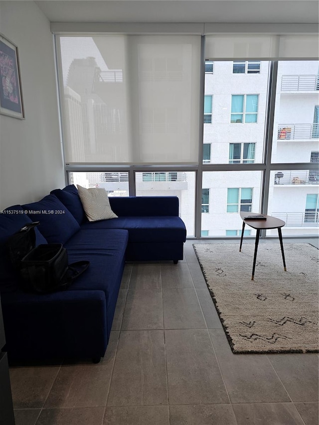 tiled living room featuring expansive windows