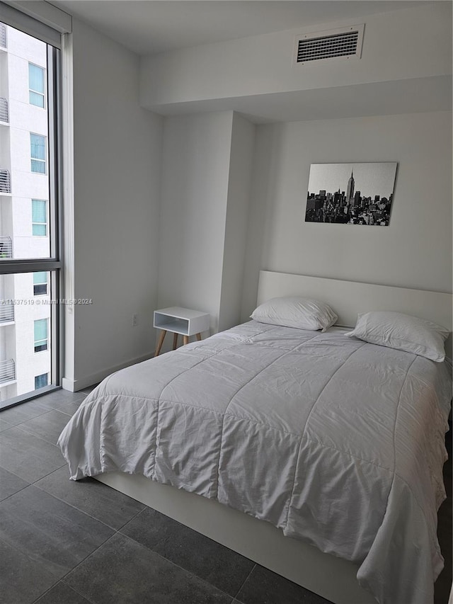 bedroom featuring dark tile floors