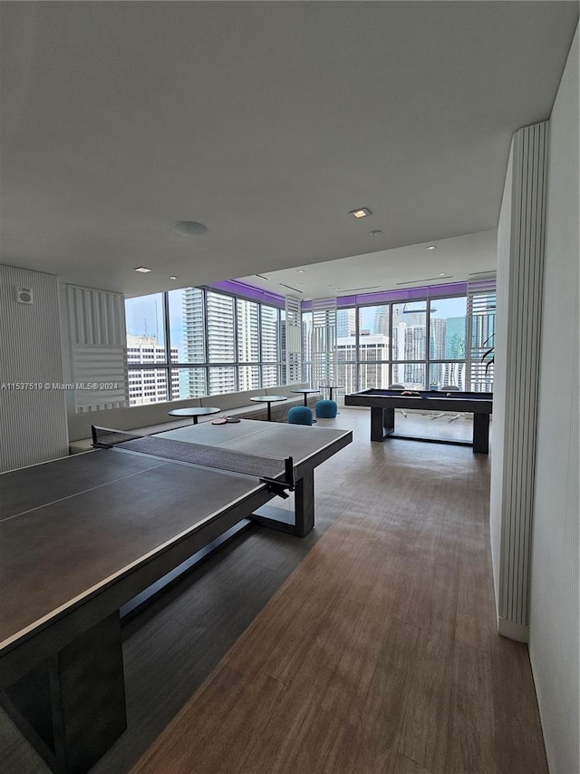 rec room with hardwood / wood-style floors and floor to ceiling windows