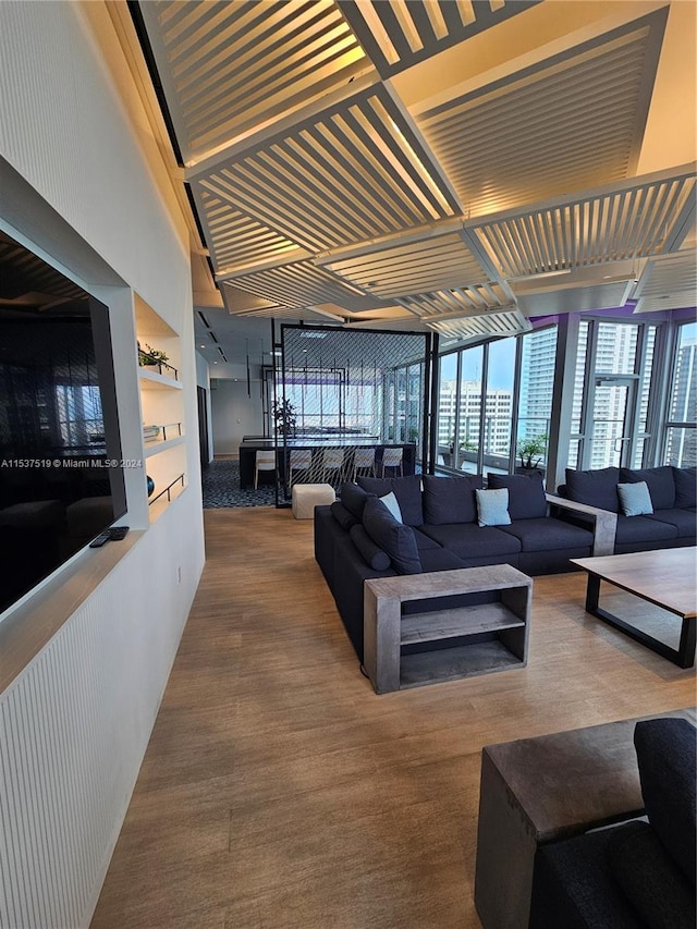 living room with floor to ceiling windows and built in shelves