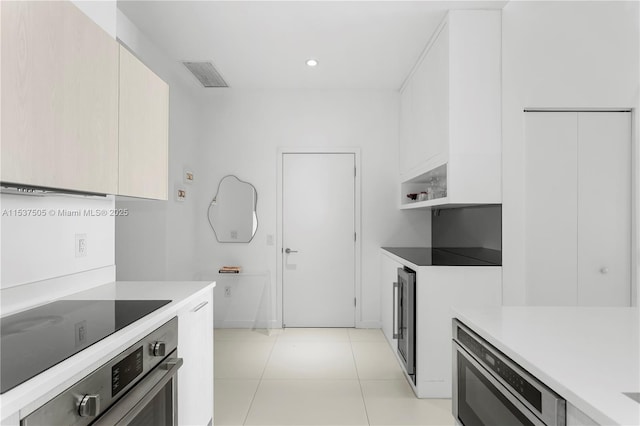 kitchen featuring light tile patterned floors, light countertops, visible vents, appliances with stainless steel finishes, and modern cabinets