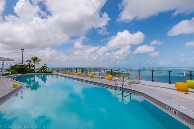 community pool featuring a water view