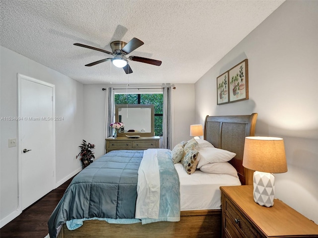 bedroom featuring dark hardwood / wood-style floors, a textured ceiling, and ceiling fan