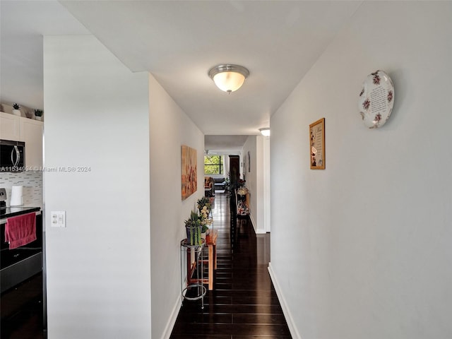 corridor featuring dark hardwood / wood-style flooring