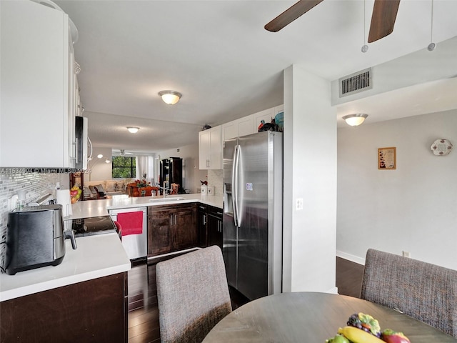 kitchen featuring dark hardwood / wood-style floors, ceiling fan, stainless steel fridge with ice dispenser, dark brown cabinets, and tasteful backsplash