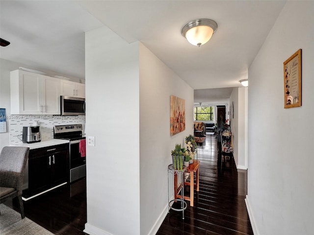 hallway with dark hardwood / wood-style floors