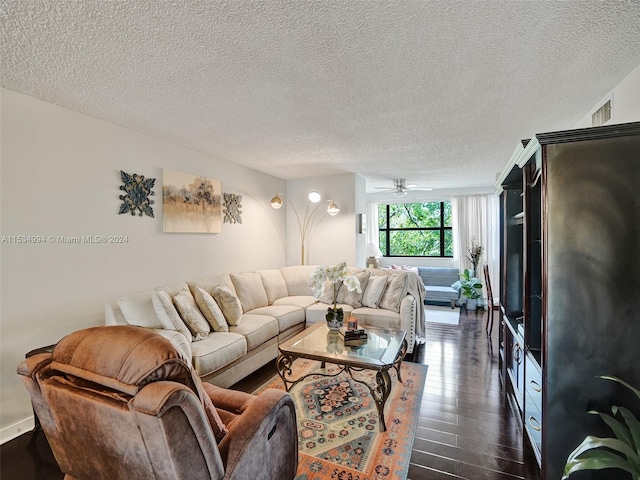 living room with ceiling fan, dark wood-type flooring, and a textured ceiling