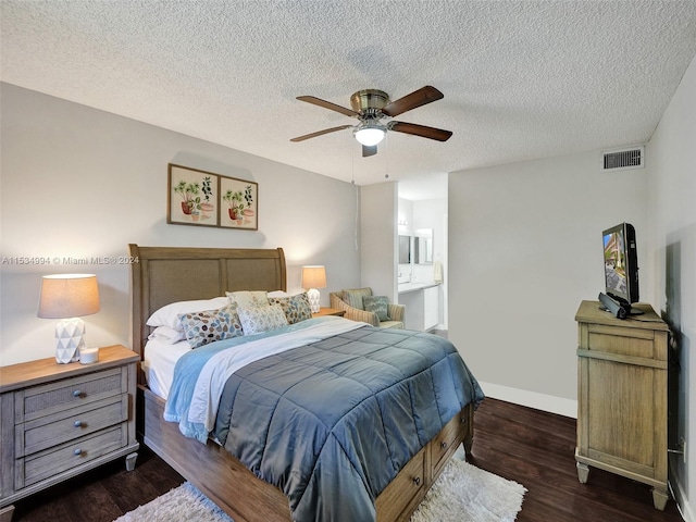 bedroom featuring ensuite bathroom, a textured ceiling, ceiling fan, and dark wood-type flooring