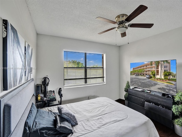 bedroom with a textured ceiling and ceiling fan