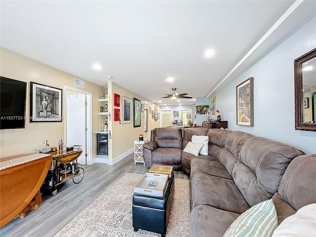 living room featuring light wood-type flooring and ceiling fan