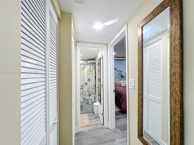 corridor with light hardwood / wood-style floors