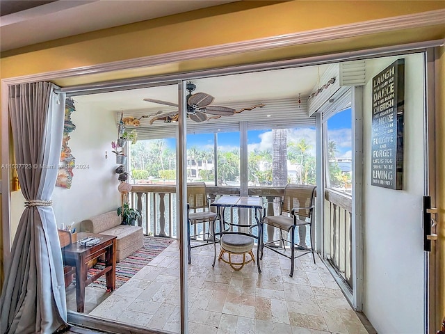 sunroom / solarium with plenty of natural light and ceiling fan