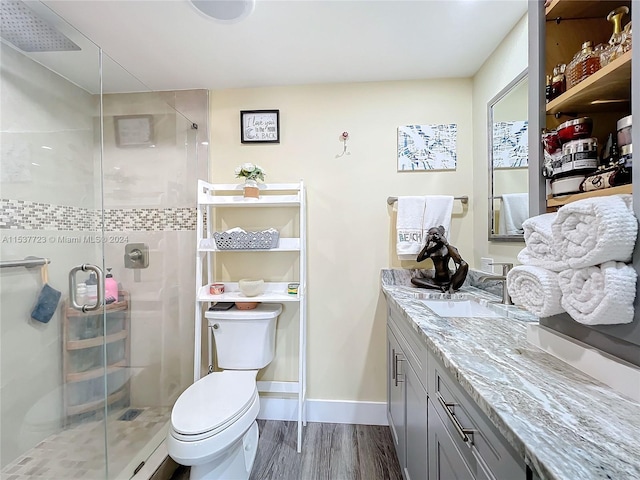 bathroom with hardwood / wood-style flooring, vanity, toilet, and an enclosed shower