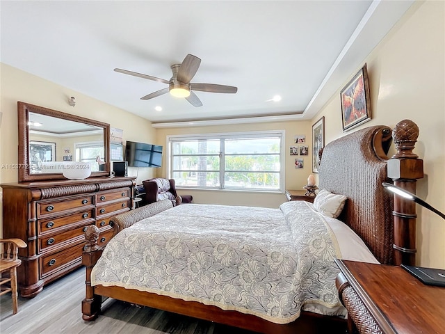 bedroom featuring ornamental molding, ceiling fan, and light hardwood / wood-style floors