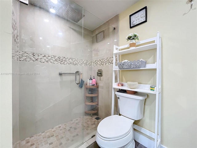 bathroom featuring toilet and walk in shower