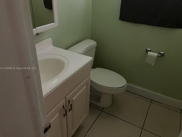 bathroom with vanity, tile flooring, and toilet